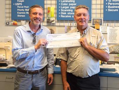 Marc Richard and VBCBA Treasurer Danny Howes holding a check